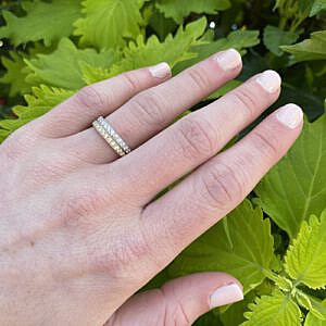 white & yellow gold micro pave wedding bands stacked on models hand